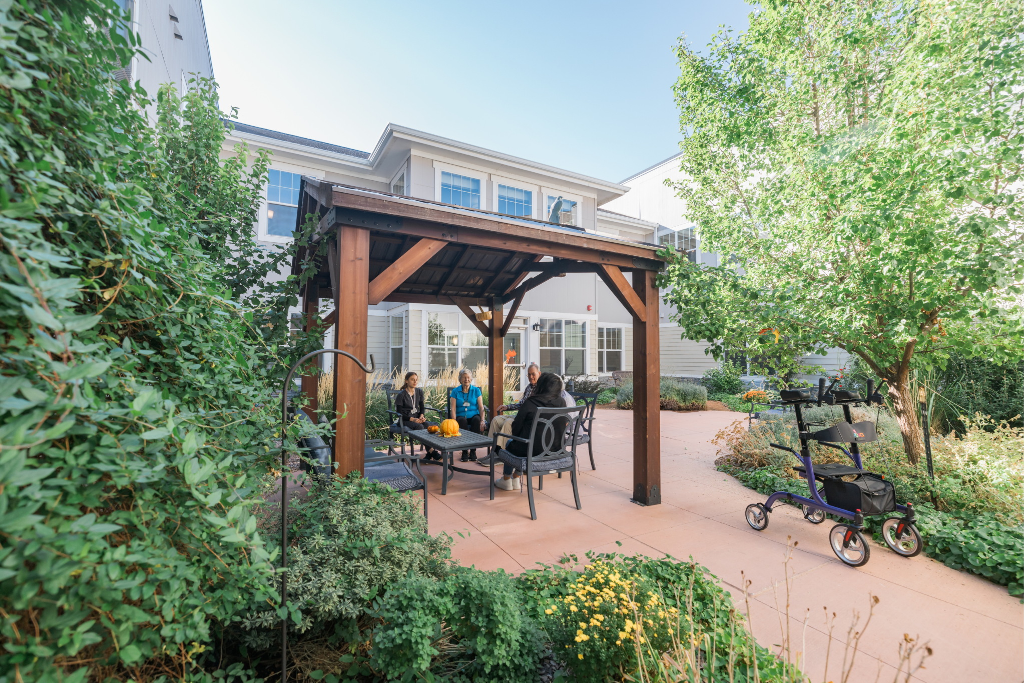 residents and team member enjoying the fall outside on the pergola 7 large landscape